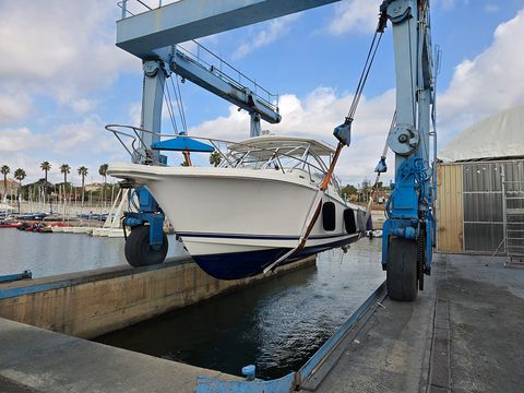 Boat lifted on the boatyard travel lift